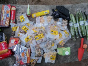 A fine selection of pine kernels, pumpkin seeds and dried fruit. On the left is a stack of coffee packages from the bin as well